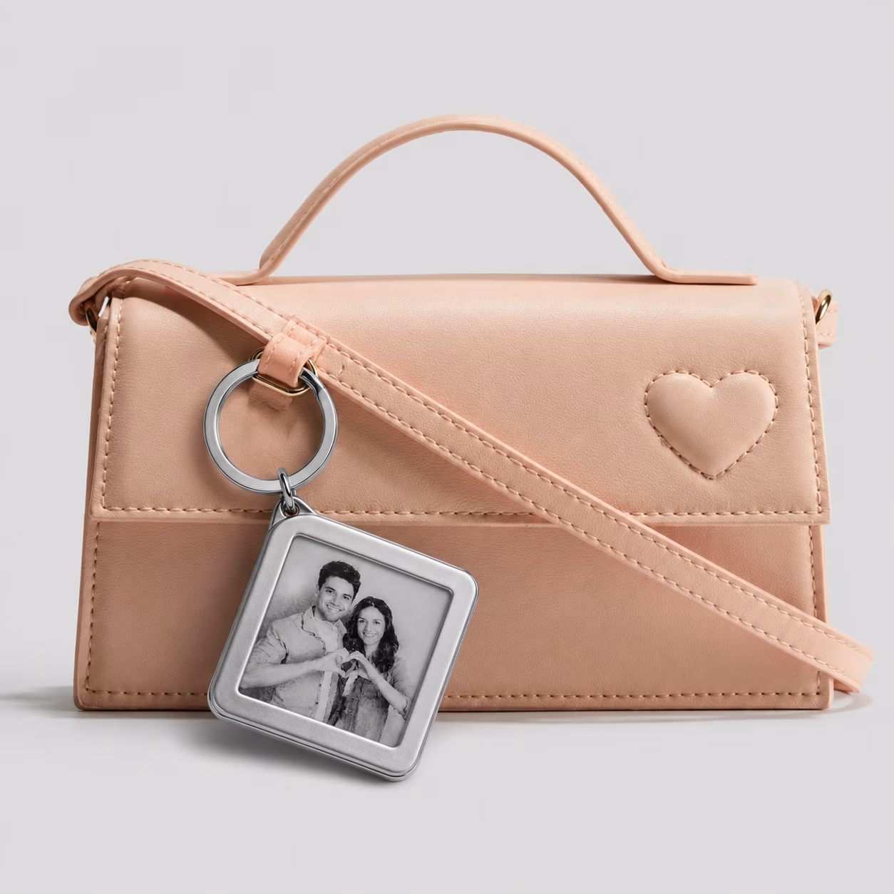 Photo display key-chain attached to a handbag